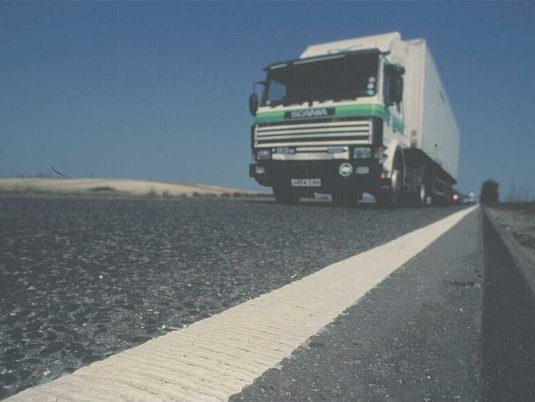 Prismo® Rainline® hot applied thermoplastic applied on highway road surface as profiled white diagonal line.