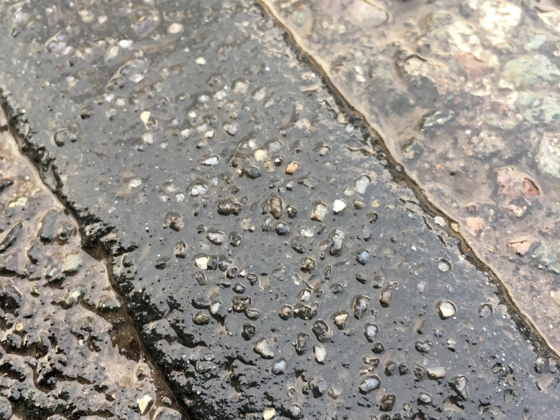 Close-up of Prismo PFT Overbanding preformed thermoplastic road marking strip showing surface texture and embedded aggregate