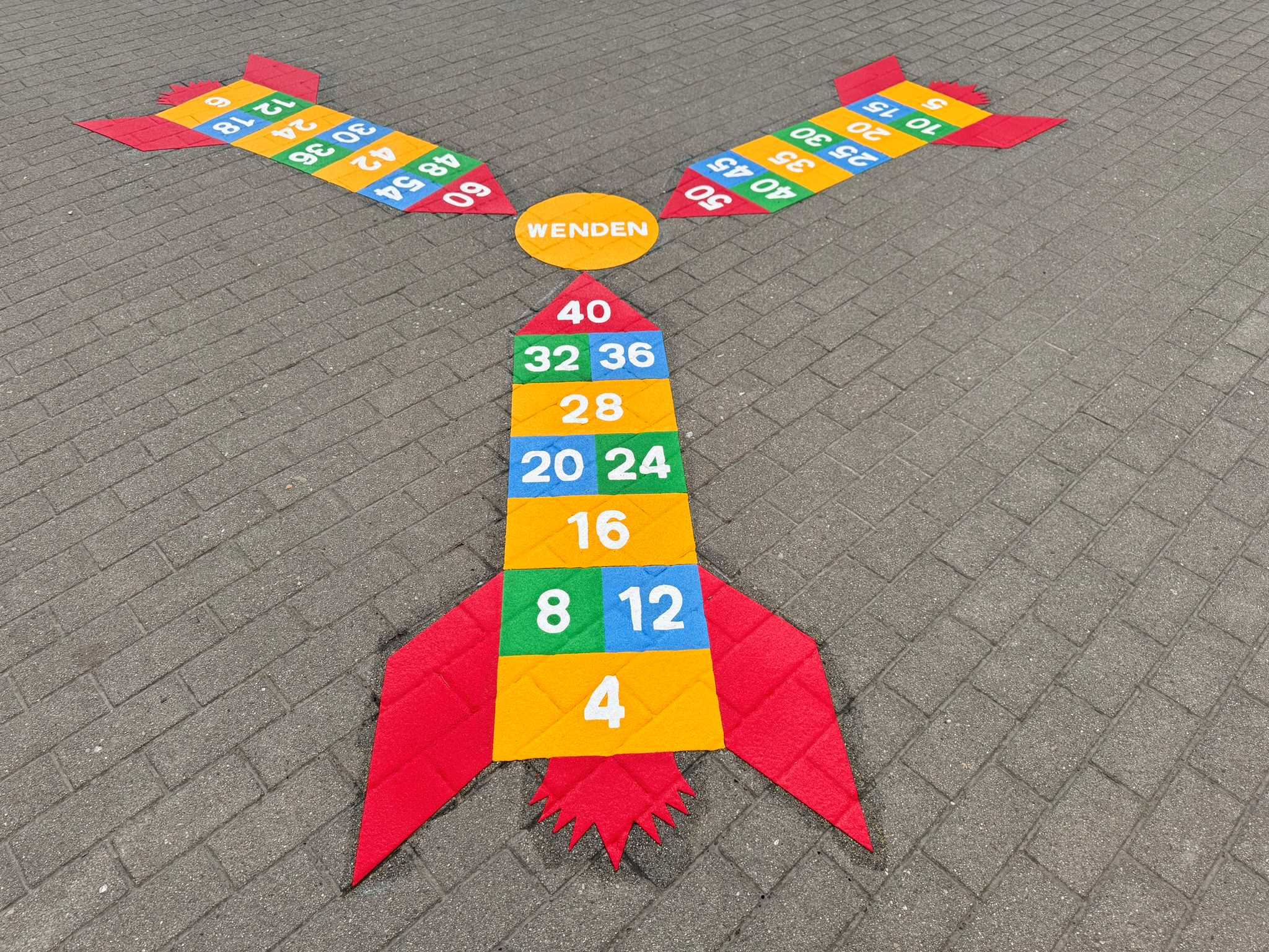 Three colourful rocket ship playground markings in Germany displaying different times table number patterns, made from Prismo preformed thermoplastic