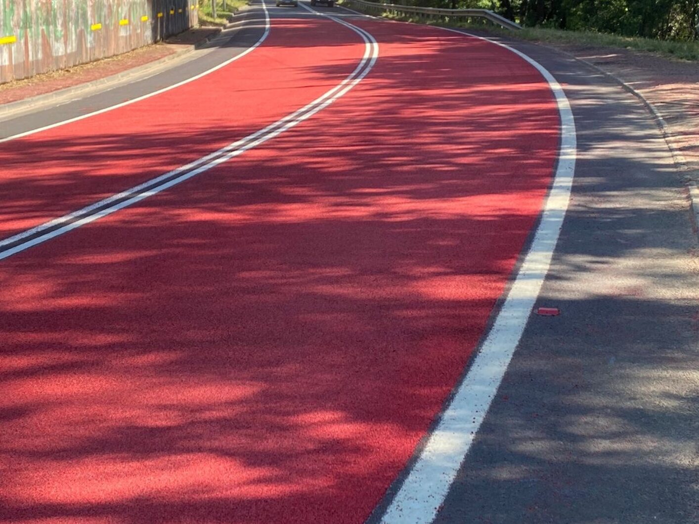 Red Prismo Tyregrip high friction surfacing applied on a bend of a main road in Chile