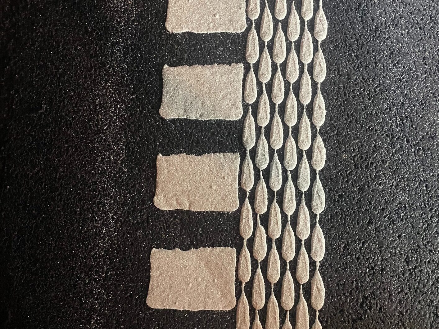 Close-up of Prismo® Multidot structured hot applied thermoplastic applied as both dotted and dashed line marking.