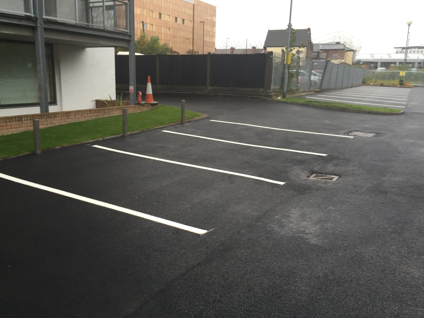 Prismo® Lifeline® hot applied thermoplastic applied as thin white lines on road surface to mark parking spaces at car park in Manchester.