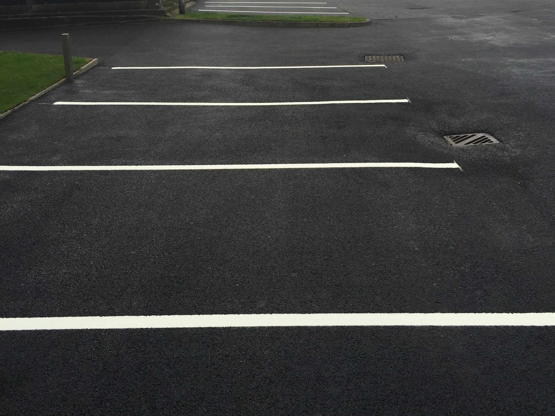 Thin white lines used for parking spaces at car park using Prismo® Lifeline® hot applied thermoplastic.
