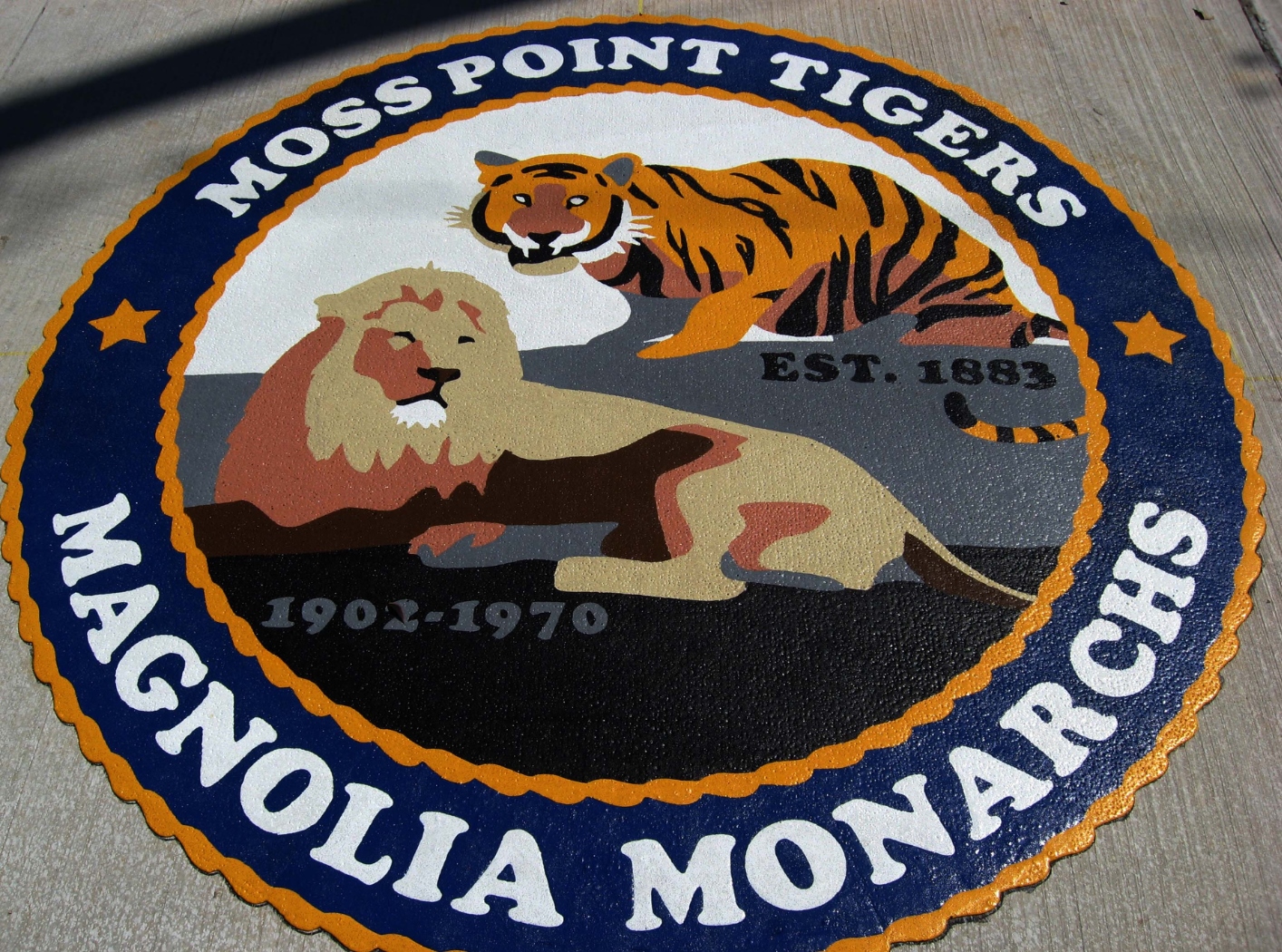 Highly detailed sports team logo featuring a lion and tiger, made from Prismo preformed thermoplastic applied to an outdoor surface.