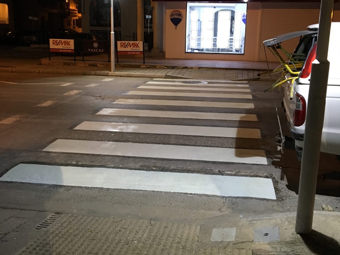White pedestrian crossing applied with Prismo® Preformed Thermoplastic on a Maltese street at night, illuminated by street lighting