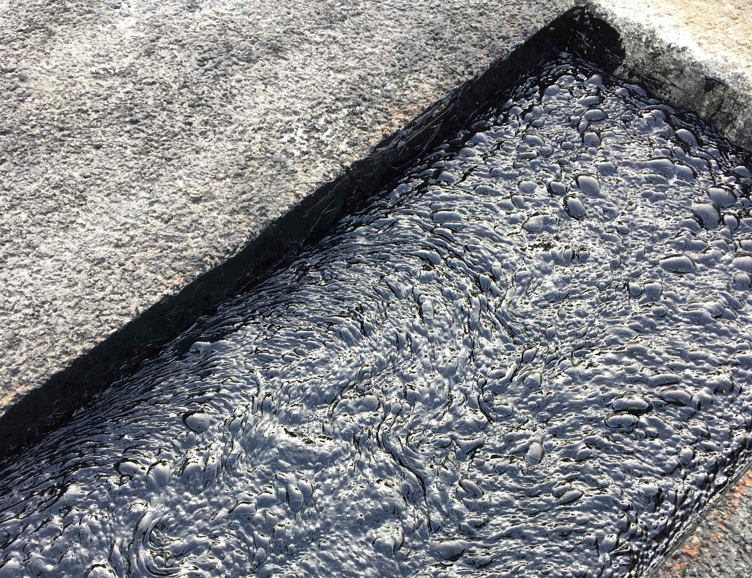 Close-up view of Prismo Thormajoint binder layer, part of its high-performance bituminous road repair products.
