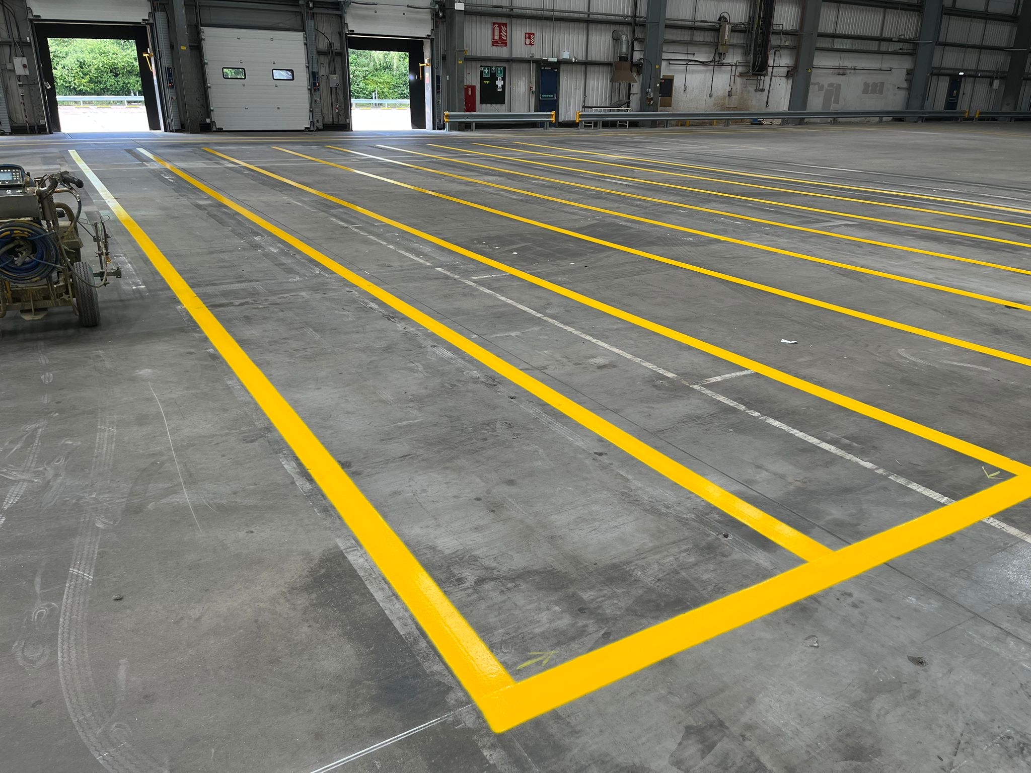 Prismo Epoxyline and Acrylic Transparent Paint yellow lines applied on indoor flooring in the UK