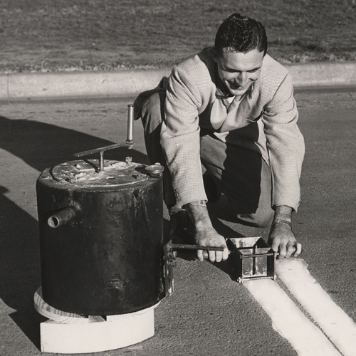 historic-road-marking-worker-with-paint-tin
