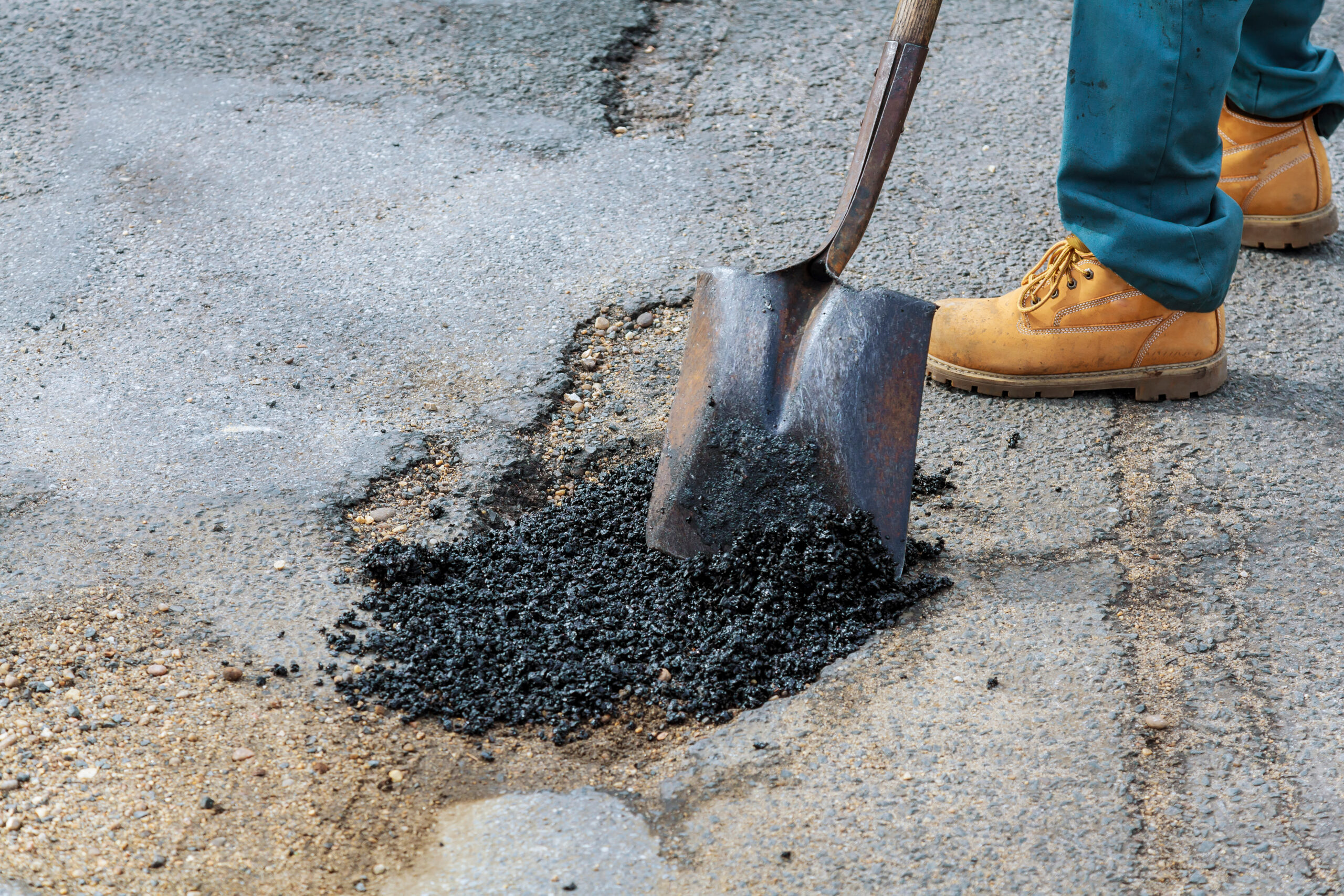 Prismo Preformed Thermoplastic pothole repair being installed on a road