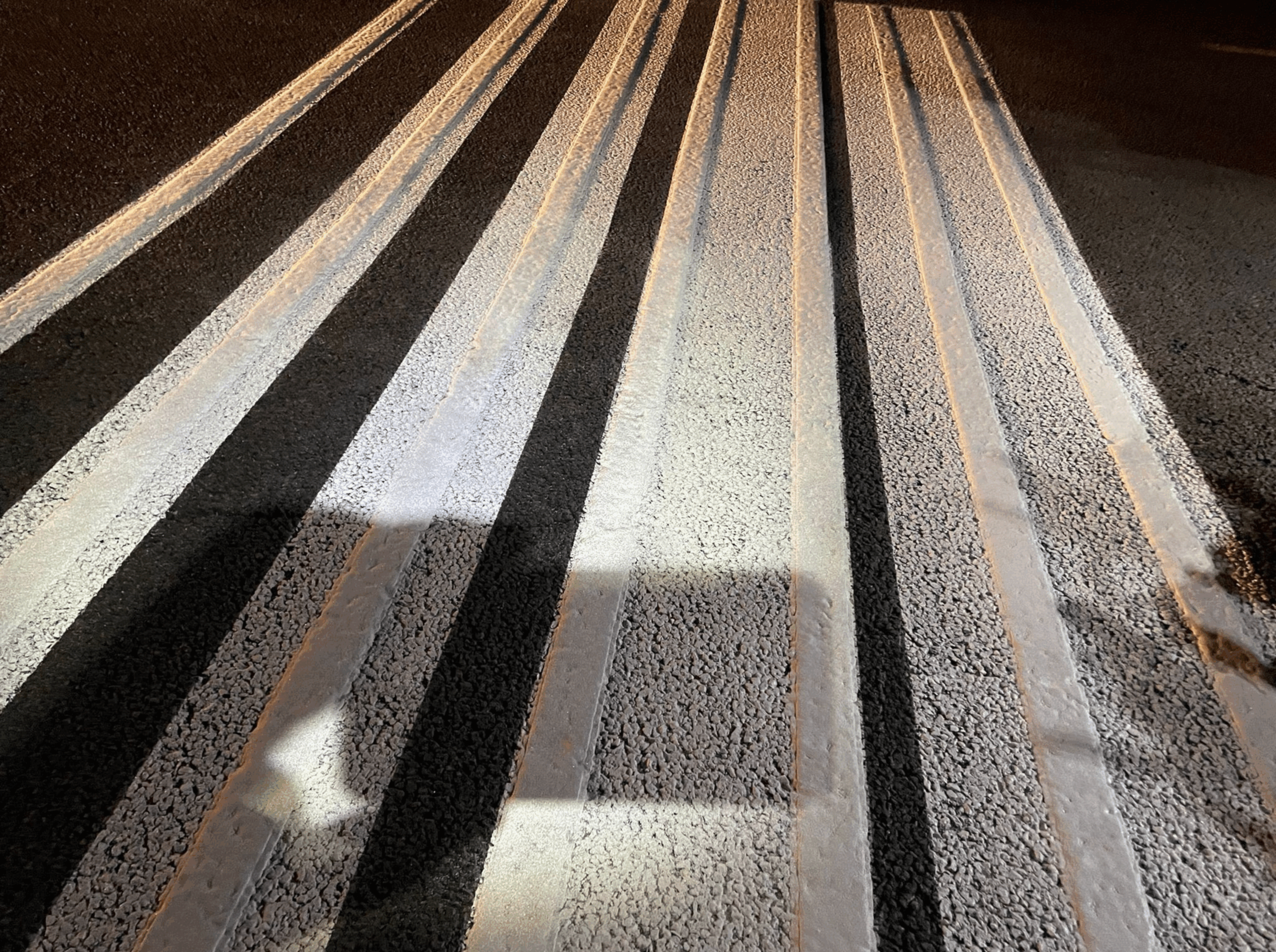 Close-up of Prismo Preformed Thermoplastic rumble bar road marking at Rosignano Toll Gate, Tuscany, Italy