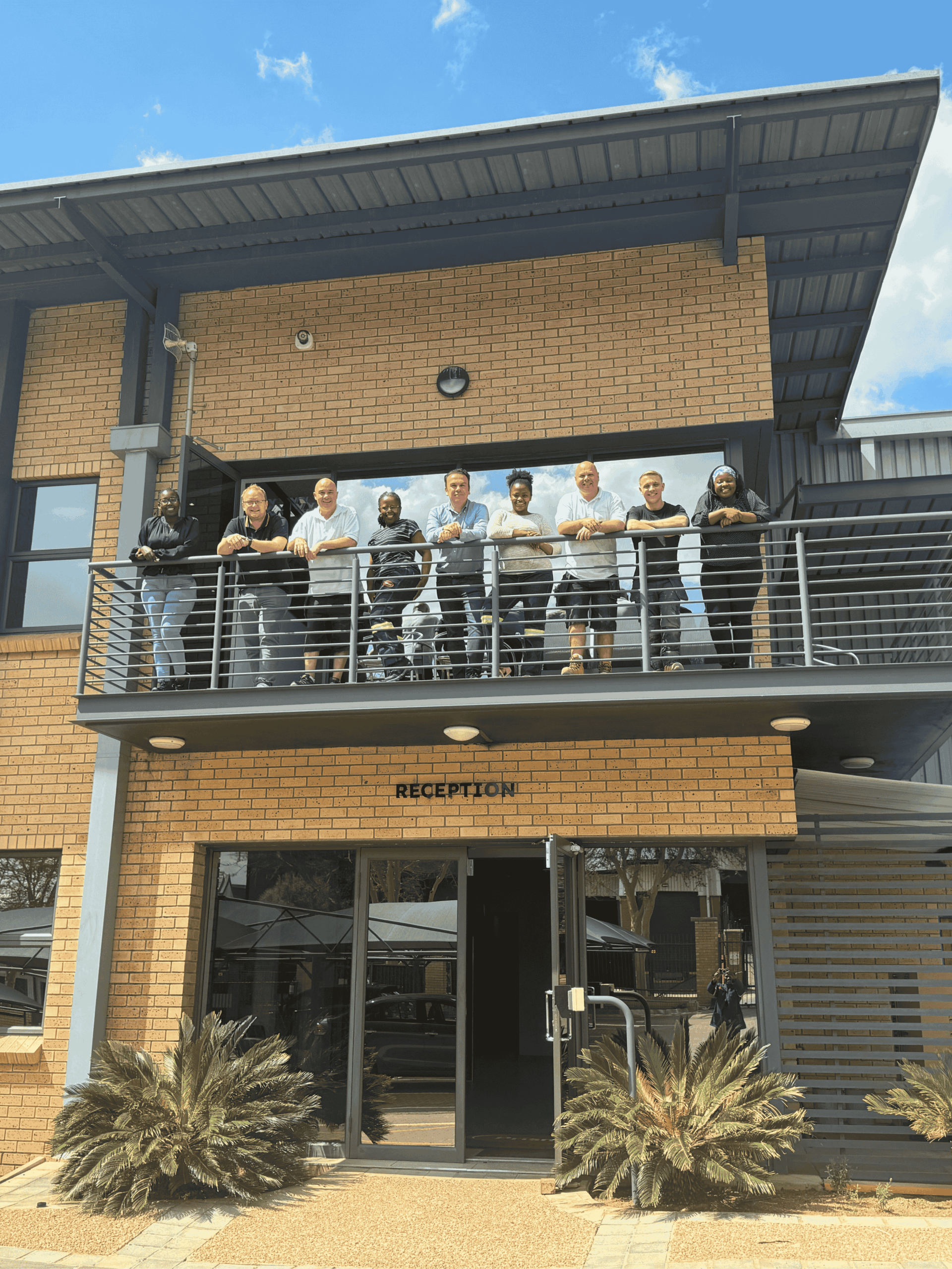 Prismo team on balcony in South Africa