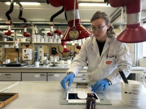 A laboratory technician demonstrating product testing at Vernisol’s Codogno site