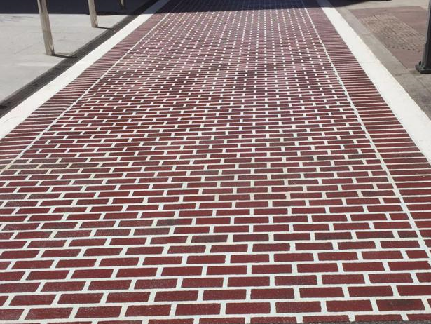 Full view of Prismo’s Urban Patterns decorative road marking in white and chestnut, part of their preformed thermoplastic road marking range.
