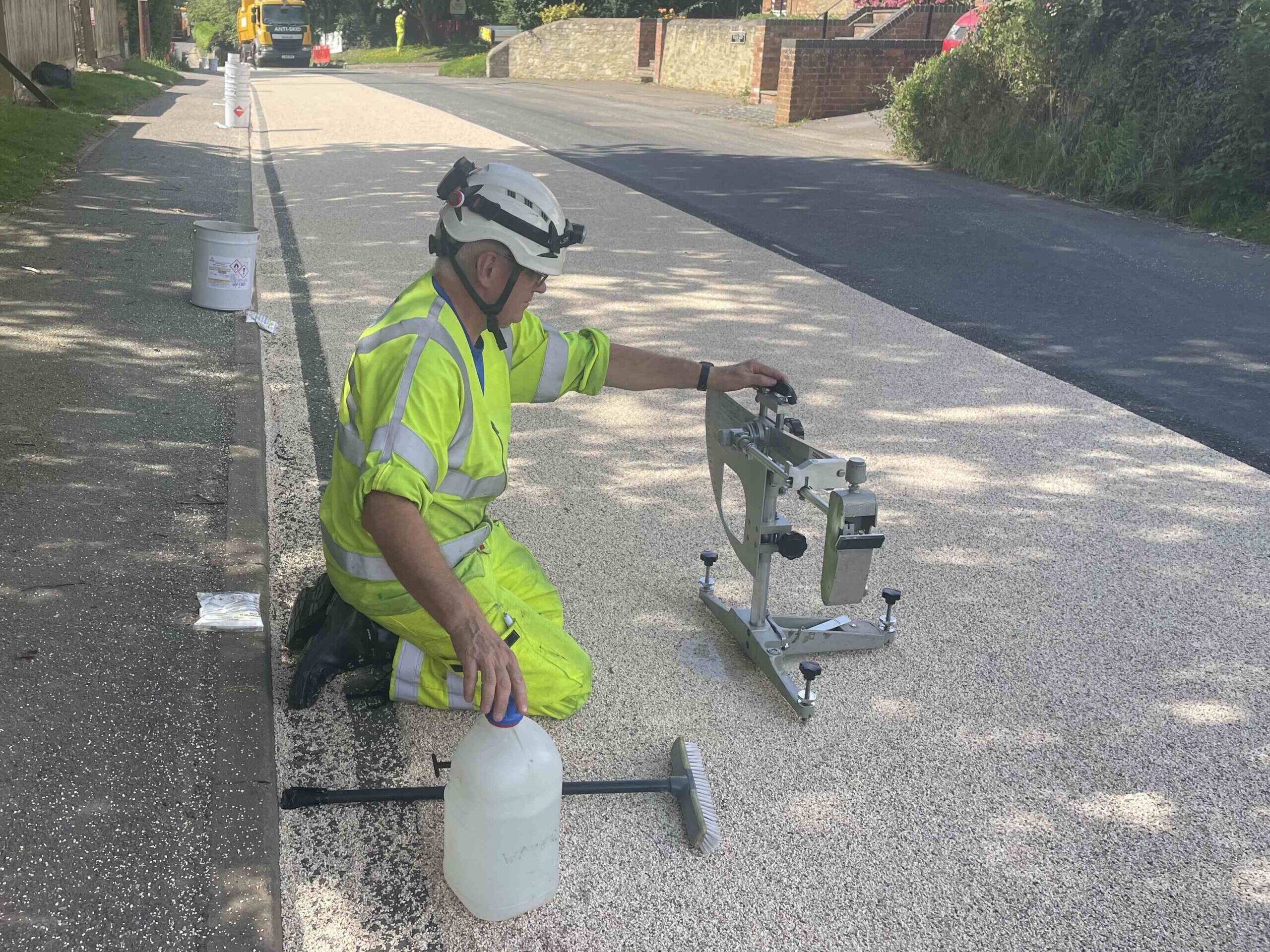 Contractor testing skid resistance after applying Prismogrip high friction surfacing