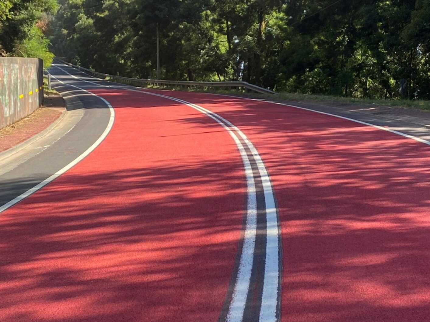 Red Prismo Tyregrip high friction surfacing applied on a bend of a main road in Chile